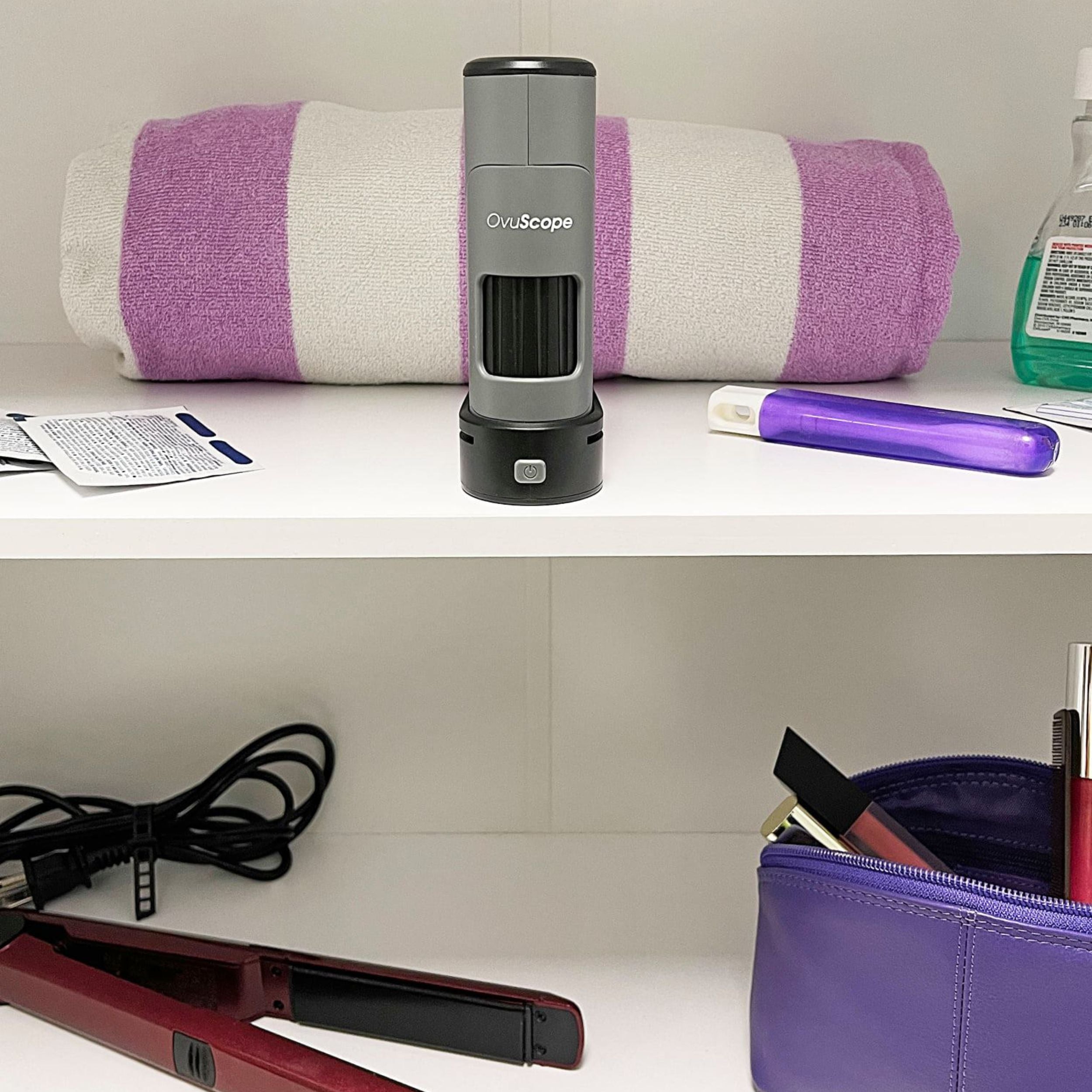 OvuScope with towel, hair straightener, and womens personal items